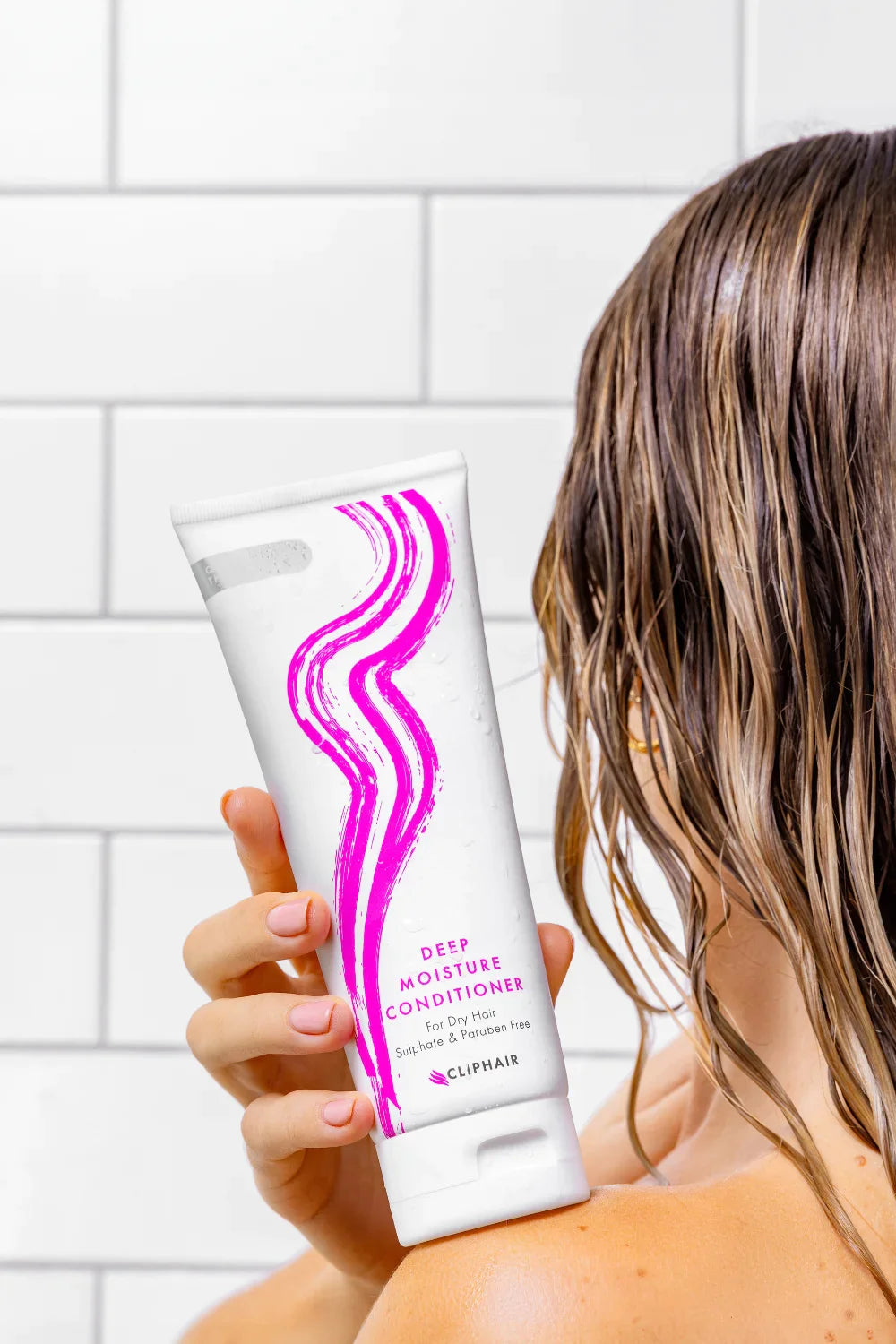 Model Holding Deep Moisture Conditioner Bottle